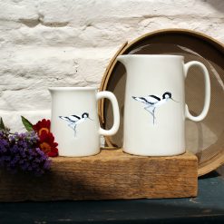 Two sized jugs featuring the Avocet design with flowers
