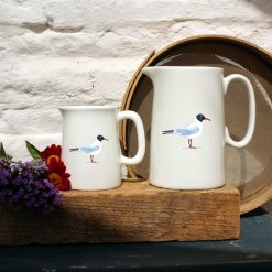 Two sized jugs featuring the Gull design with flowers