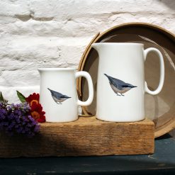 Two sized jugs featuring the Nuthatch design with flowers