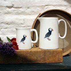 Two sized jugs featuring the Puffin design with flowers
