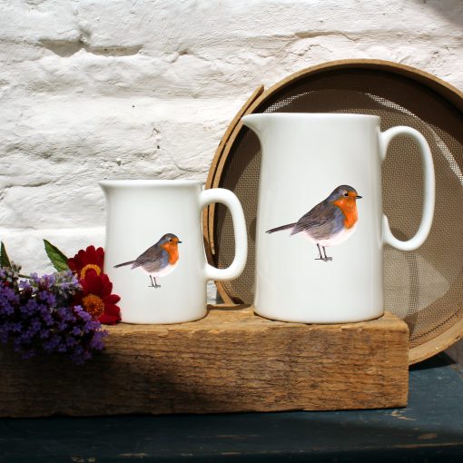 Two sized jugs featuring the Robin design with flowers