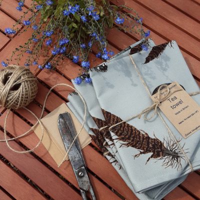 Feather and egg tea towel tied with string