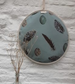 Feather & Egg AGA lid cover hanging on white wall