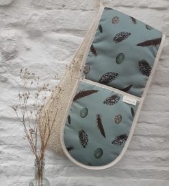 Feather & Egg oven gloves on white wall