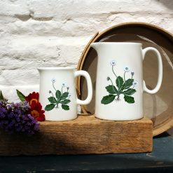 Two sized jugs featuring the Daisy design with flowers