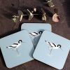 Three Avocet coasters with flower