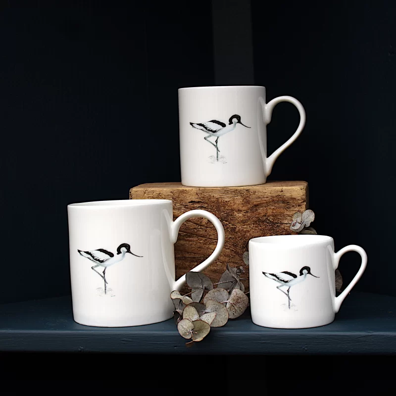 Three Avocet mugs with leaves on shelf