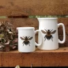 Two Bee jugs with flower