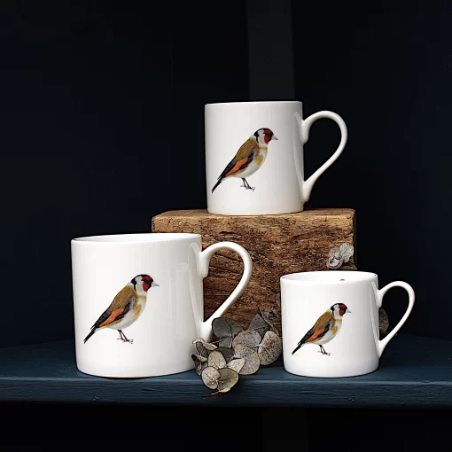 Three Goldfinch mugs with leaves on shelf