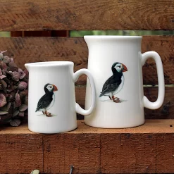 Two Puffin jugs with flower