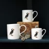 Three Puffin mugs with leaves on shelf