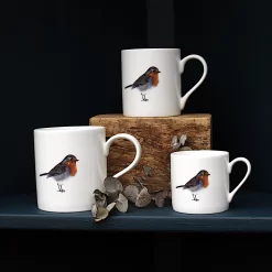 Three Robin mugs with leaves and on a shelf