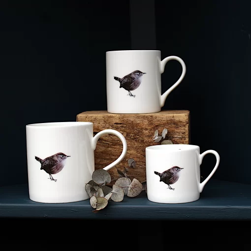 Three Wren mugs with leaves on shelf