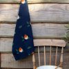 Robin tea towel on hook and chair