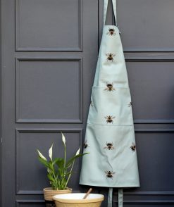 Bee apron on hook with bowl and plant
