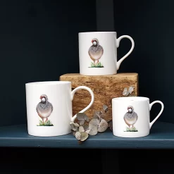 Three Partridge mugs with leaves on shelf