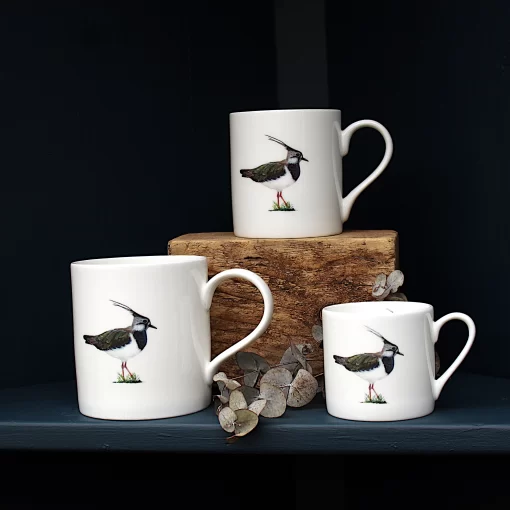 Three Lapwing mugs with leaves on shelf